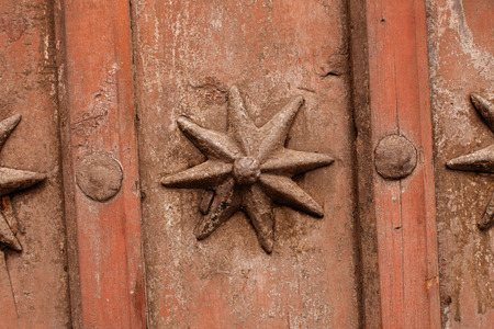 Nice old door with wrought iron decorationの写真素材