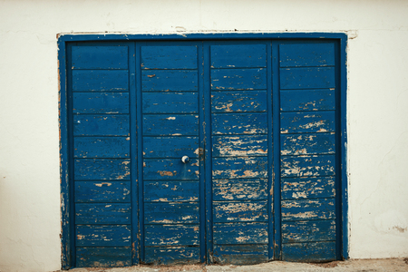 Blue wooden door worn by the passage of timeの写真素材