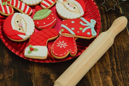 Beautiful cookies for Christmas in red on a wooden background