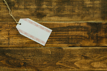 Empty shopping tag template on a rustic wood backgroundの写真素材