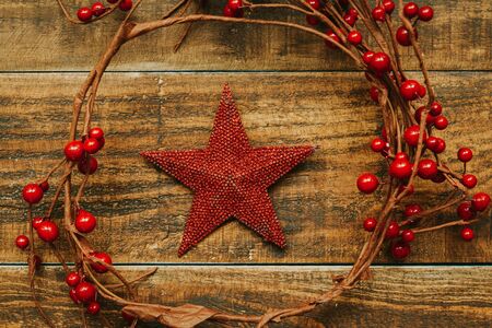 Red Christmas star on a rustic wooden backgroundの写真素材