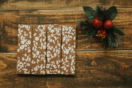 Delicious nougat typical sweet Christmas on a rustic wooden background
