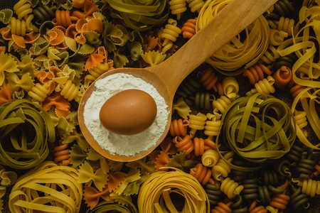 different types of colored pasta with various shapesの写真素材
