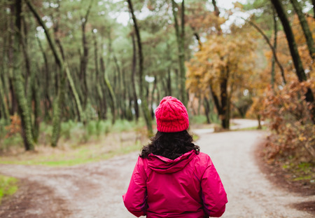Matured woman hiking in the forest at winter
