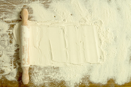 Sifted flour and rolling pin on the table. Kitchen backgroundの写真素材