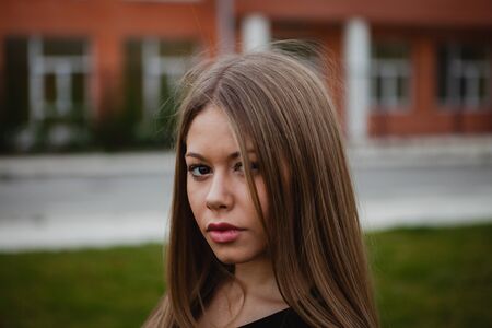 Blond pretty girl with long hair in the streetの写真素材