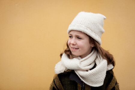 Pretty little girl in the street with wool hatの写真素材