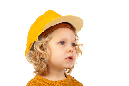 Cute little kid with yellow helmet isolated on a white backgroundの写真素材