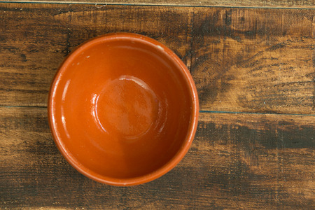 Empty bowl for the kitchen on a wooden backgroundの写真素材