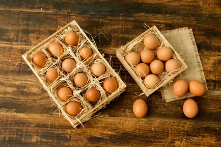 Eggs on straw placed on a wooden table