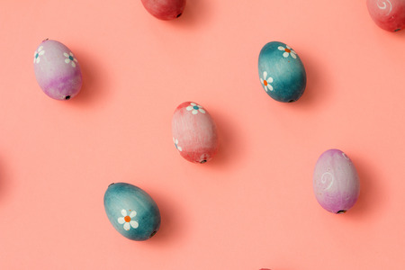 Colourful Easter Eggs ordered on a pink background