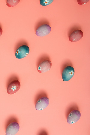 Colourful Easter Eggs ordered on a pink backgroundの写真素材