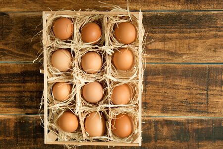 Eggs on straw placed on a wooden table
