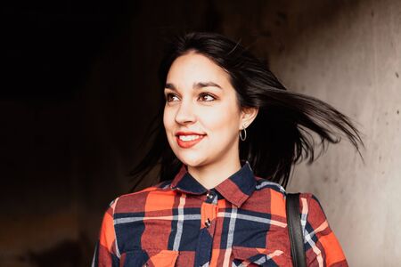 Pretty brunette girl with plaid shirt and red lipsの写真素材