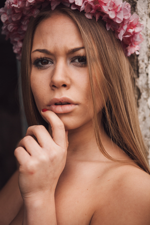 Beauty portrait of attractive blond girl with a beautiful pink headbandの写真素材