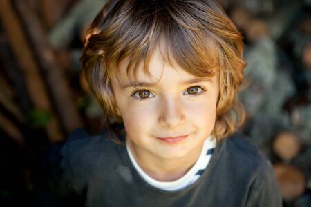 Adorable small child in the field looking at camera