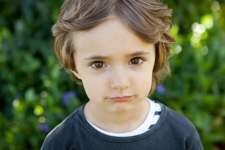 Adorable small child in the field looking at camera