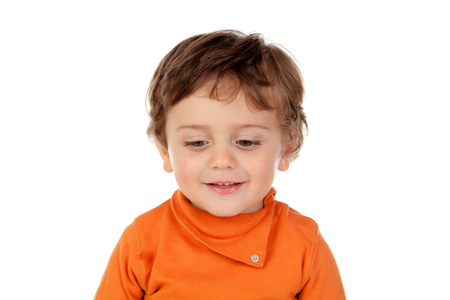 Beautiful little child two years old with orange jersey isolated on a white backgroundの写真素材