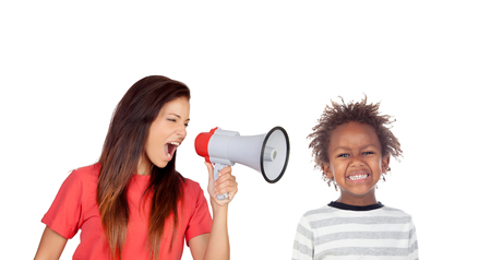 Craizy mum shouting by a megaphone to her son isolated on a white backgroundの写真素材