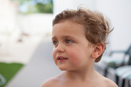 Beautiful baby two years old outside with wet hairの写真素材