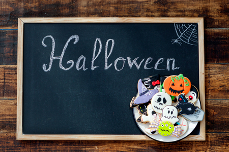 Sweet terror is coming. Blackboard with the word "Halloween" and cookiesの写真素材