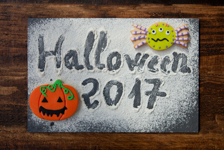 Sweet terror is coming. The words "Halloween 2017" on a slate with flour and cookiesの写真素材