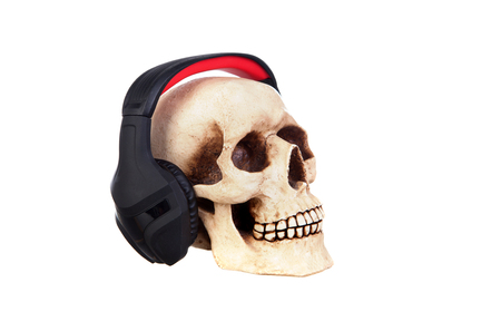 Human skull in headphones isolated on a white background.の写真素材