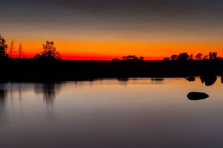 Beautiful landscape in a lake during the sunset with amazing colorsの写真素材