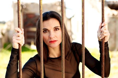 Attractive woman behide the bars with red lips