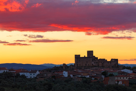 Silhouette of a amazing castle over a yellow skyの写真素材