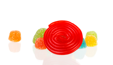 Red spiral of licorice and jelly beans isolated on a white backgroundの写真素材