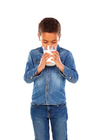 Adorable child drinking milk isolated on a white backgroundの写真素材