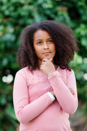Cute African American girl smiling in the street with afro hairの写真素材