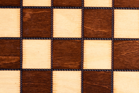 Wooden chessboard close up for background