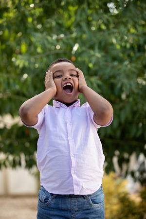 Surprised colombian child in a park with a funny expressionの写真素材