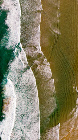 Beautiful aerial view of a beach with waves. Natural textures and colors