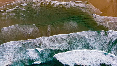 Beautiful aerial view of a beach with waves. Natural textures and colors
