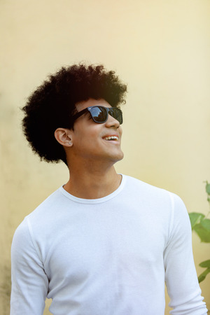 Handsome guy with afro hairstyle and sunglasses on the streetの写真素材