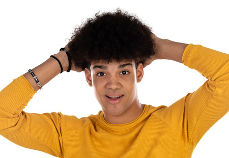 Surprised teenager boy with yellow t-shirt isolated on a white backgroundの写真素材