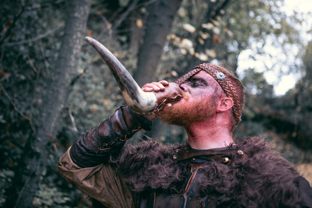 Terrifying viking with his ax and sword prepared for the fightの写真素材