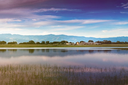 Beautiful landscape of the countryside with water, trees and a beautiful skyの写真素材