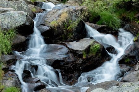 Beautiful waterfall falling on the stonesの写真素材