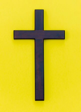 Wooden christianity symbol on a yellow backgroundの写真素材