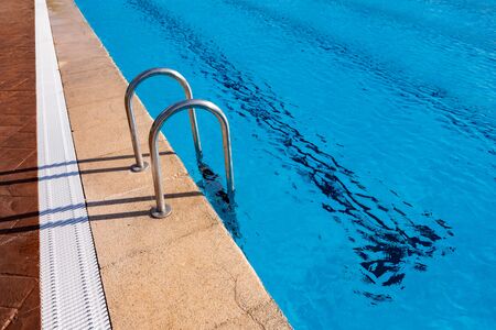 Stairs in a beautiful swimming pool with a clear waterの写真素材