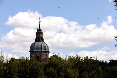 View of the top of a cathedral with a cloudy sky of backgroundの写真素材