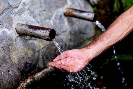 Source of two pipes with crystal clear water of the mountainの写真素材