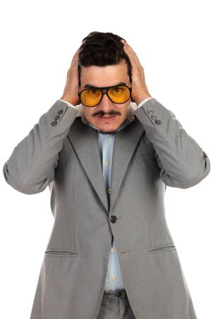 Worried businessman with vintage glasses and grey suit isolated on a white backgroundの写真素材