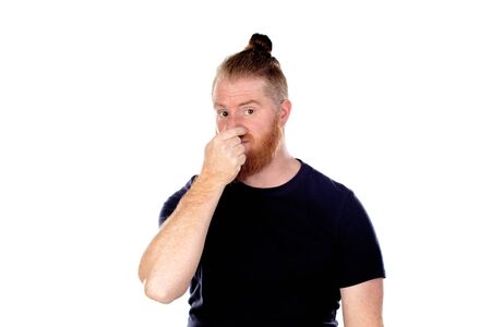 Red haired man with long beard covering his nose isolated on a white backgroundの写真素材