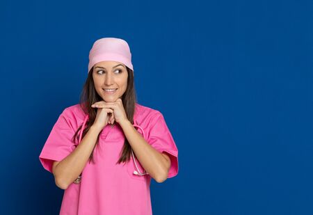 runette young woman wearing a yellow T-shirt on a yellow backgroundの写真素材
