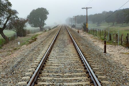 Lonely railroad track in a foggy day